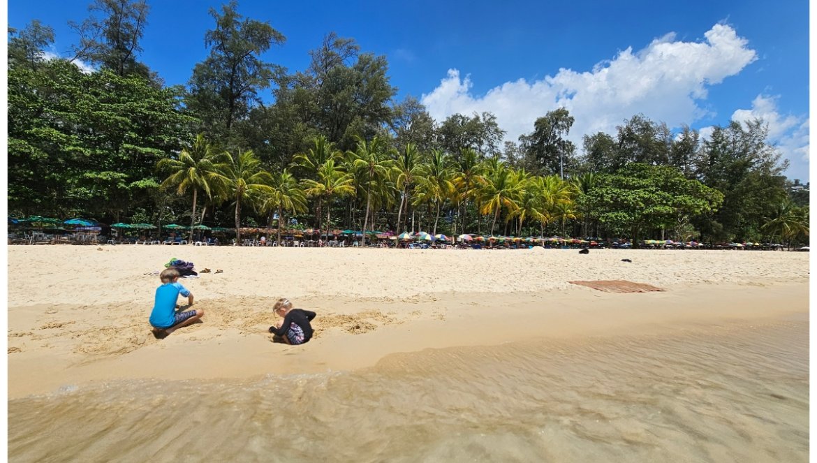 children playing on surin beach in thailand