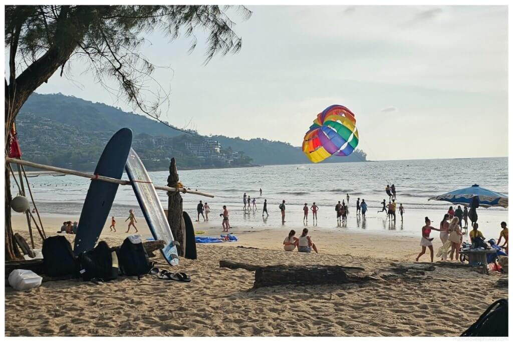 a colorful parasail taking off on kamala beach in phuket