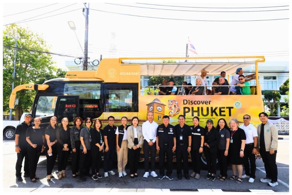 people standing in front of a Discover _Phuket yellow open top EV us